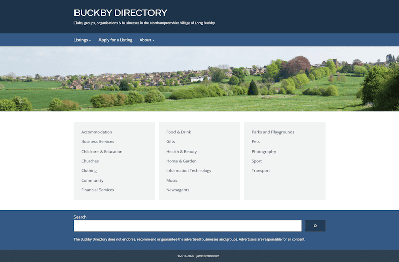 Website screenshot with navigation items listing, apply for listing and about. Hero image of a village with fields in the foreground. Boxes showing categories including accomodation, food and drink, parks and playgrounds etc.